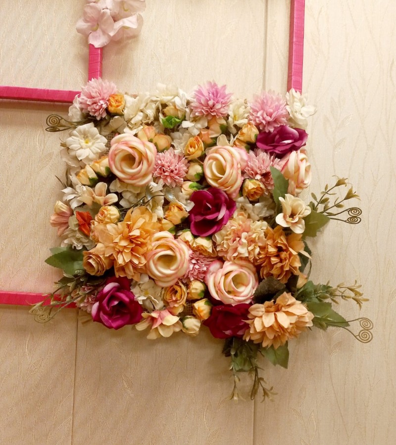 Wall hanging decoration with artificial flowers.