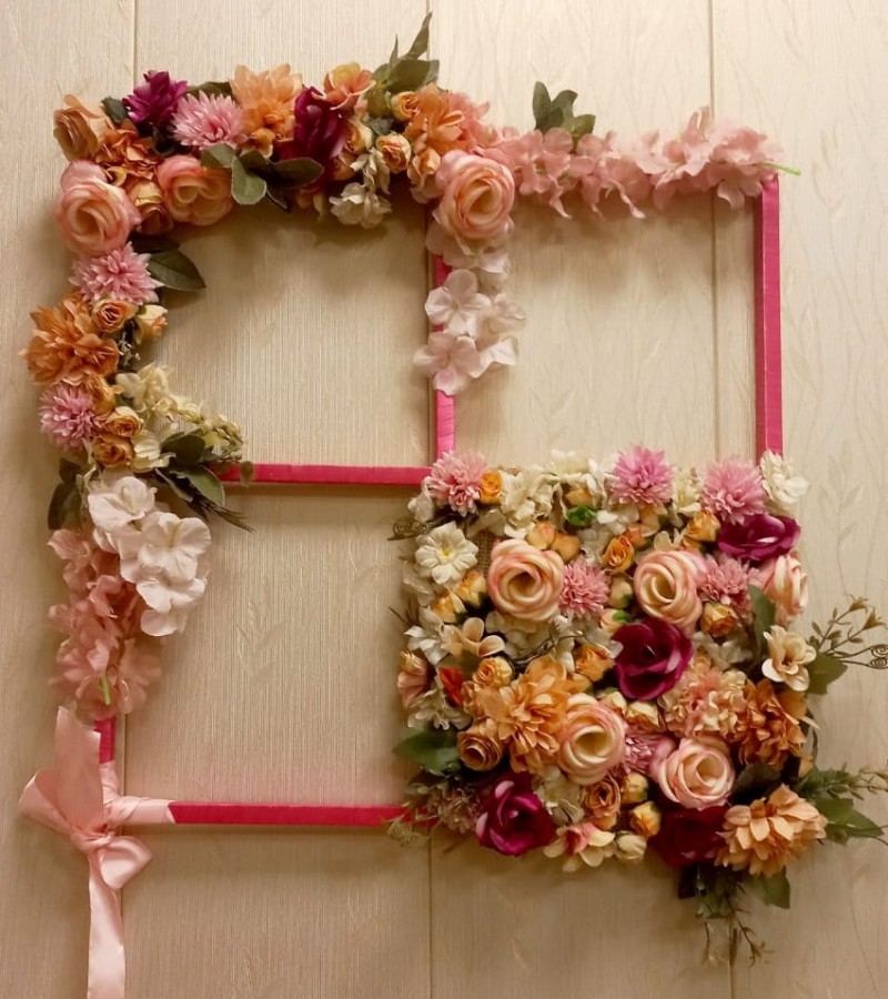 Wall hanging decoration with artificial flowers.