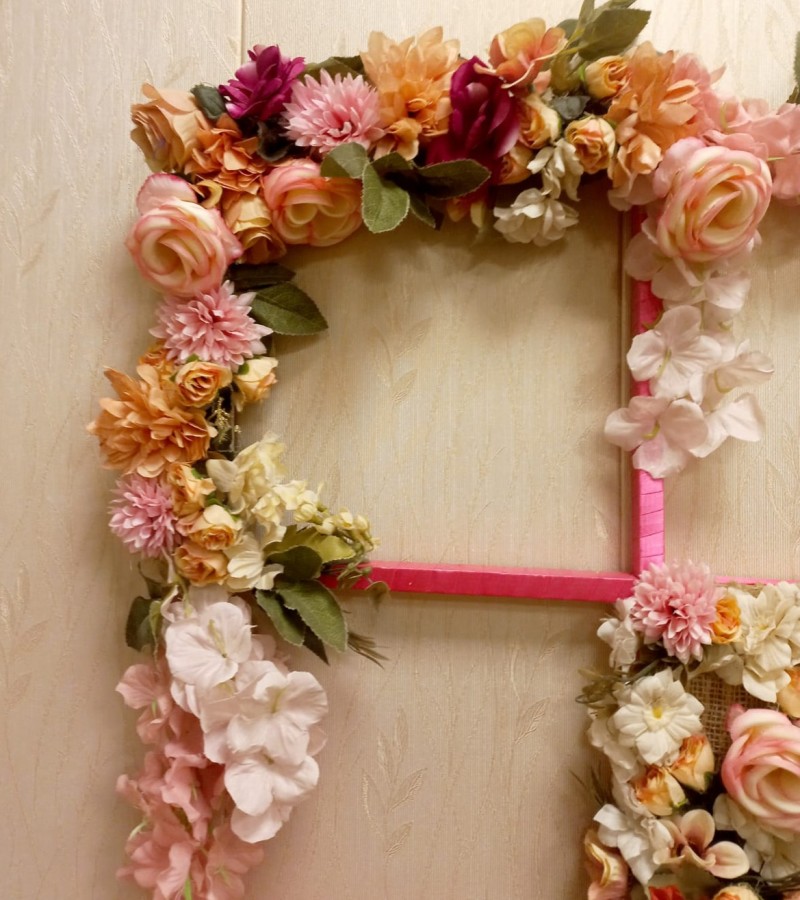 Wall hanging decoration with artificial flowers.
